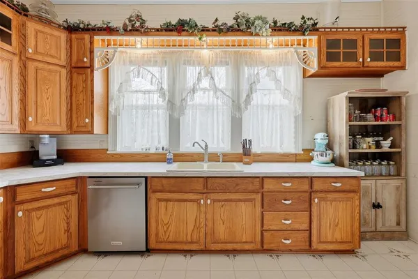 a kitchen with granite countertop a stove top oven microwave and cabinets