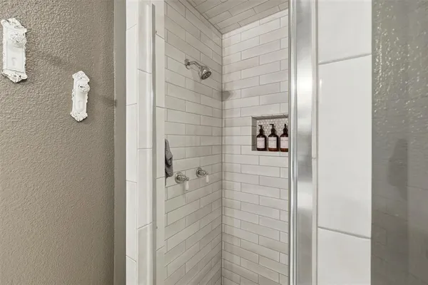 a white bath tub sitting next to a white toilet