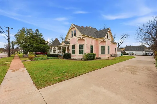 a front view of house with yard and green space