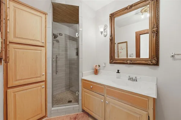 a spacious bedroom with a bed and a dresser in it