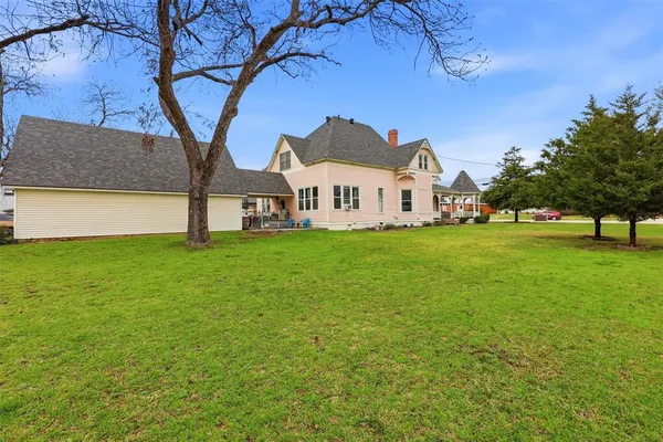 a front view of a house with a garden and yard