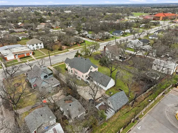 an aerial view of a house with a yard
