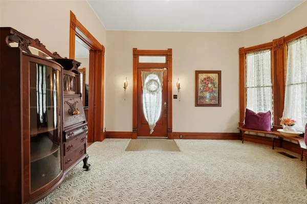 a living room with furniture pool table and a large window