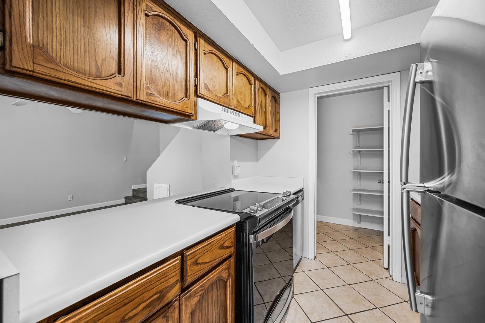 1455 North Alma School Road, Unit 11 Mesa, AZ 85201 - Photo 15 of 17 a kitchen with stainless steel appliances granite countertop a refrigerator and a stove