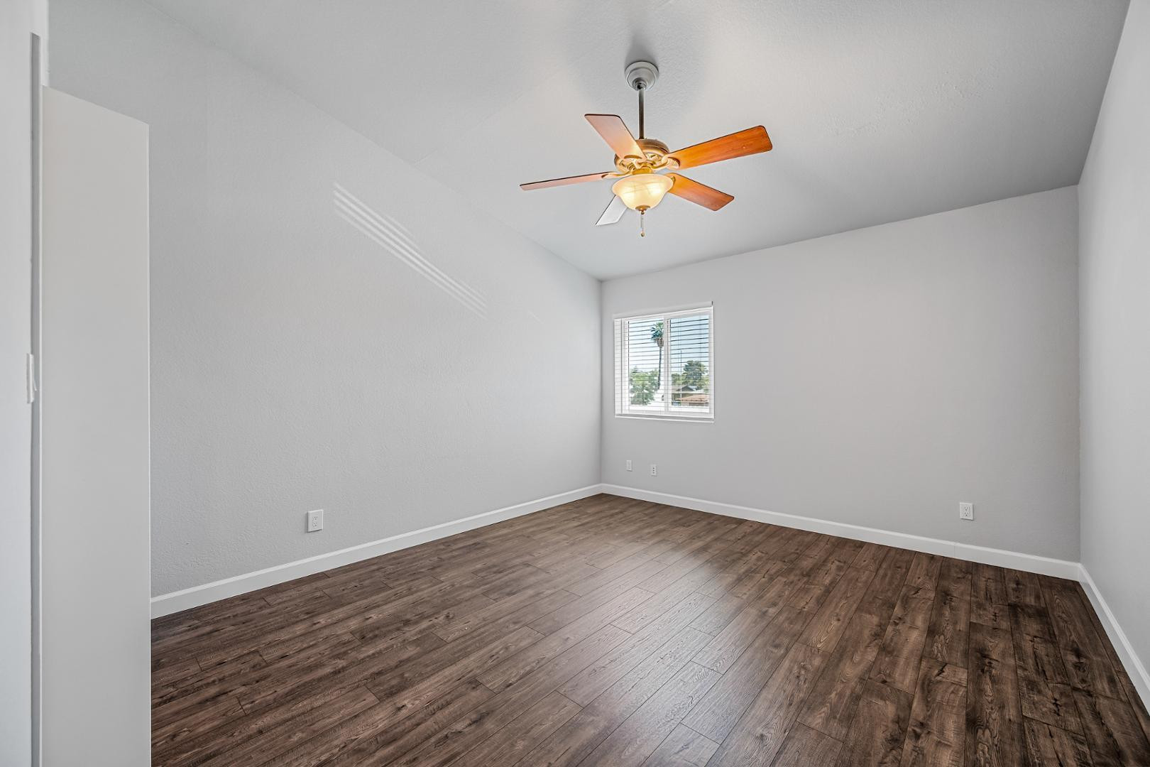 1455 North Alma School Road, Unit 11 Mesa, AZ 85201 - Photo 9 of 17 wooden floor in an empty room with a window
