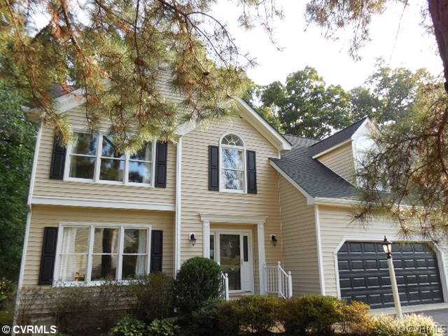 a view of house with a tree front of house