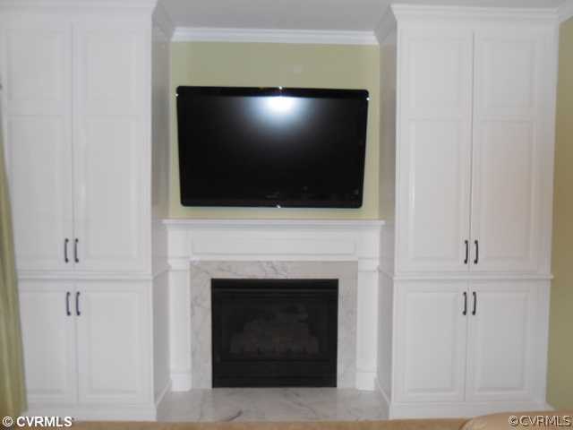 13904 Sagebrook Road Midlothian, VA 23112 - Photo 19 of 19 a living room with a fireplace and a flat screen tv