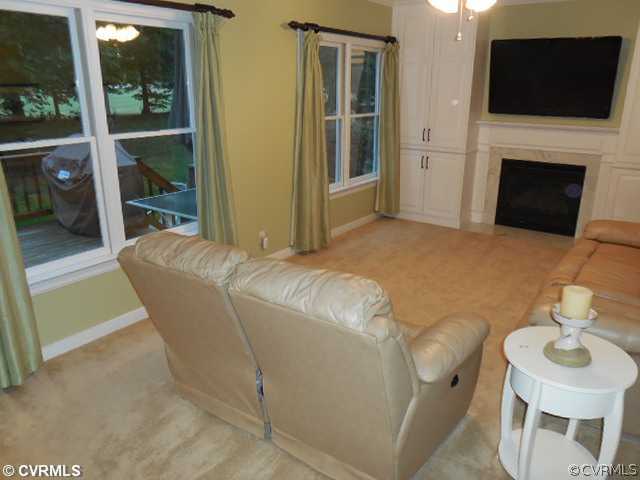 13904 Sagebrook Road Midlothian, VA 23112 - Photo 6 of 19 a living room with furniture a fireplace and a flat screen tv