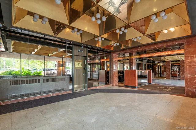 an empty room with wooden floor cabinet and windows