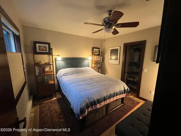 a bed sitting in a bedroom and a mirror