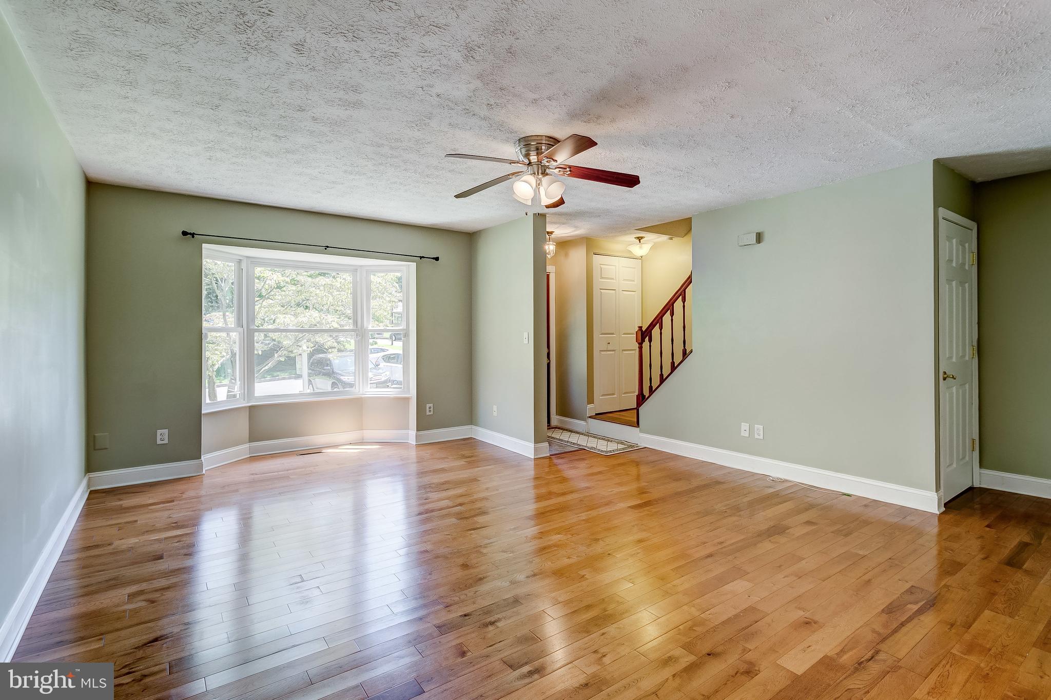 Liv Rm with bay window & ceiling fan