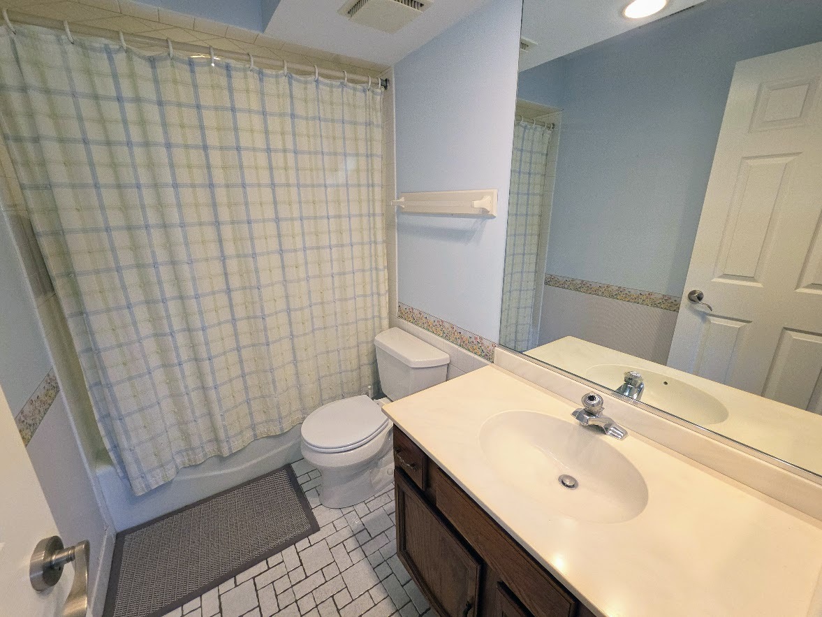 1-s150 Spring Road, Unit 5B Oak Brook, IL 60181 - Photo 14 of 14 a bathroom with a sink a toilet and shower curtain