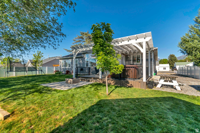 332 South 500 West Payson, UT 84651 - Photo 40 of 50 Spacious backyard featuring a manicured lawn, an elevated deck, built to hold a hot tub, with a white pergola.
