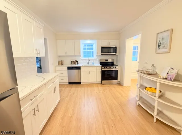 a large kitchen with a stove a sink and a refrigerator