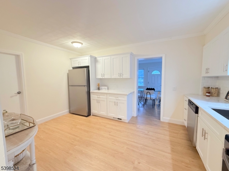 484 Bara Street Brick, NJ 08723 - Photo 8 of 15 a kitchen with a refrigerator and white cabinets