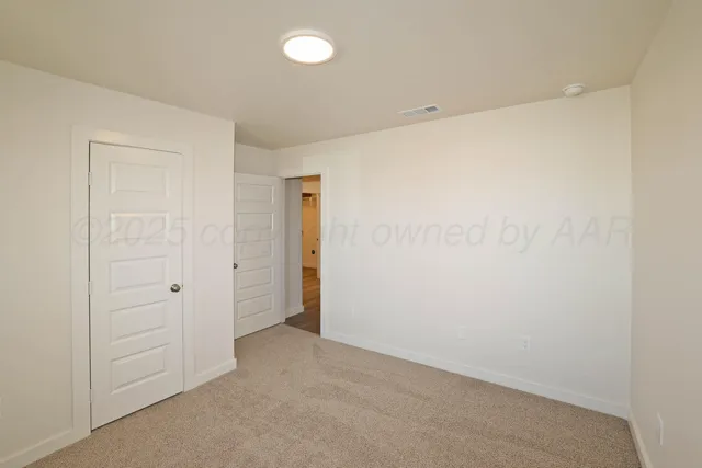 an empty room with closet area