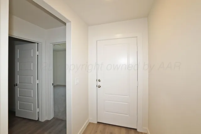 an empty room with wooden floor