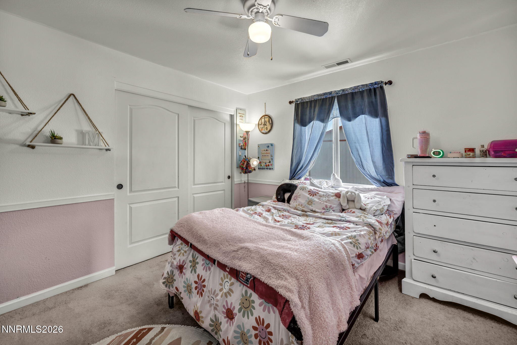 17615 Baileyville Court Reno, NV 89508 - Photo 11 of 19 a bedroom with a bed and a chandelier