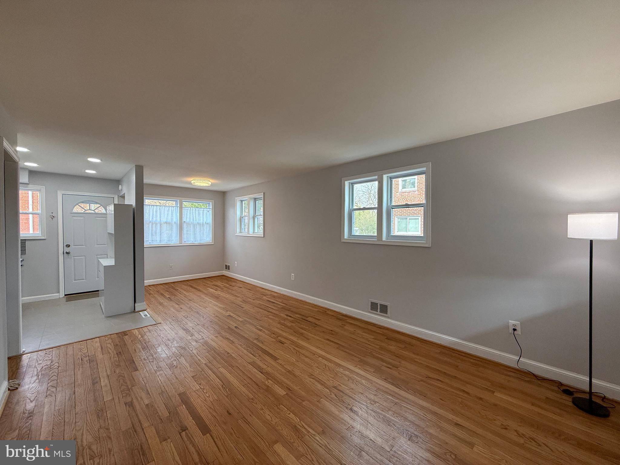8518 11th Avenue Silver Spring, MD 20903 - Photo 2 of 13 a view of an empty room with wooden floor and a window