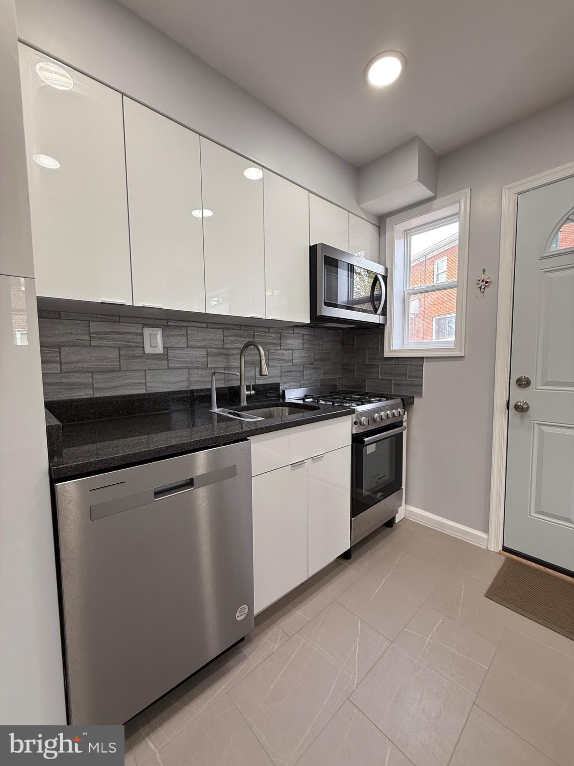 8518 11th Avenue Silver Spring, MD 20903 - Photo 4 of 13 a kitchen with stainless steel appliances granite countertop a stove a sink and a microwave