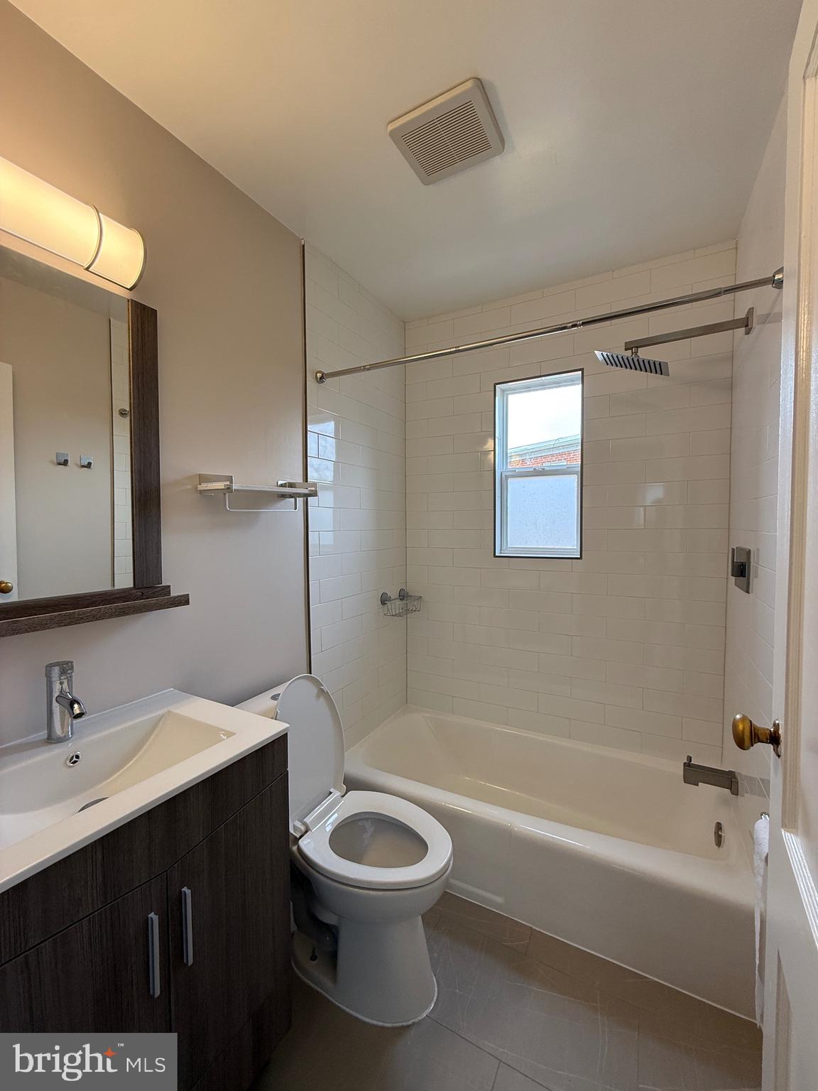 8518 11th Avenue Silver Spring, MD 20903 - Photo 6 of 13 a bathroom with a bathtub shower sink vanity and toilet
