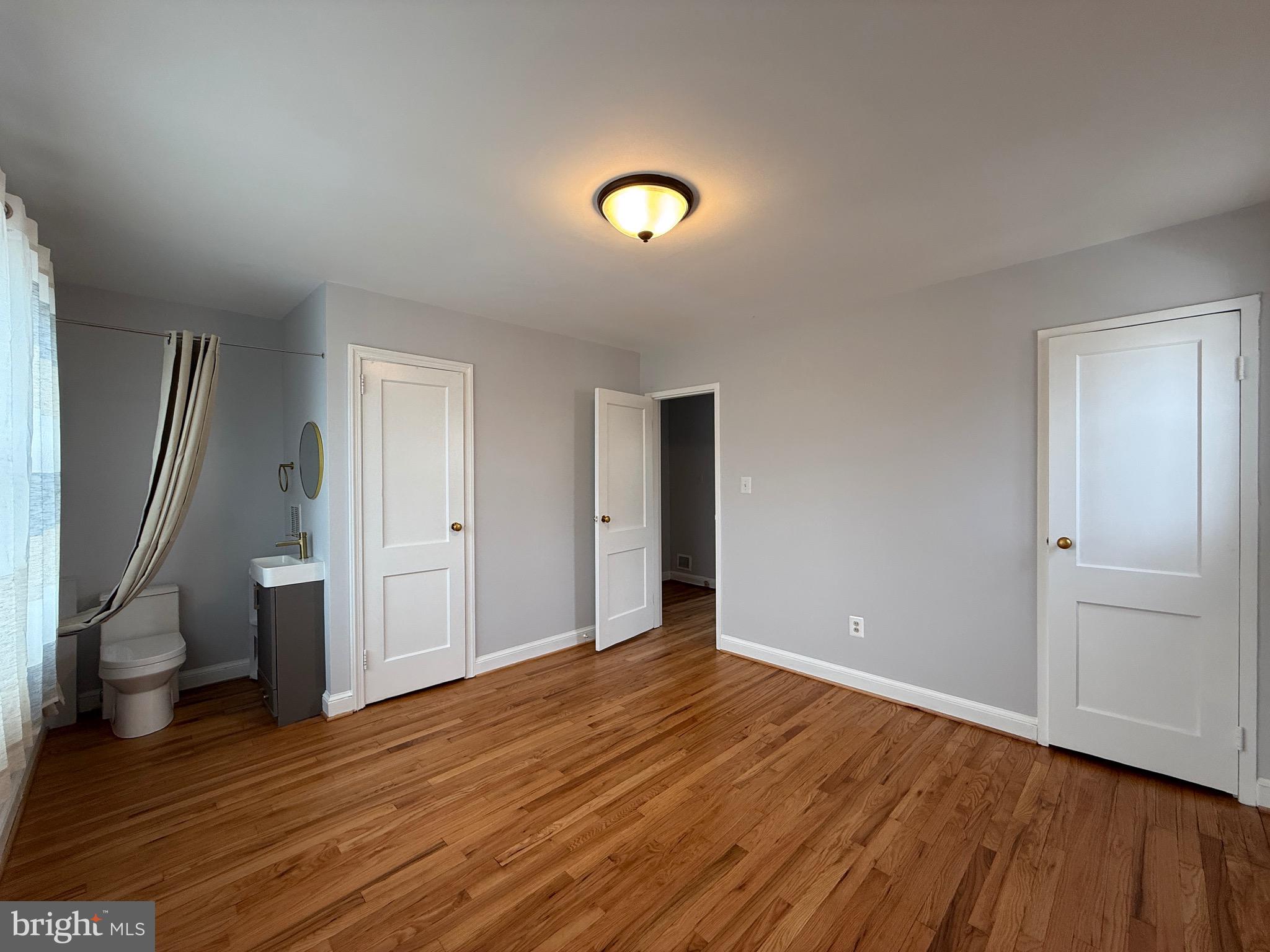 8518 11th Avenue Silver Spring, MD 20903 - Photo 8 of 13 a view of an empty room with wooden floor and a window