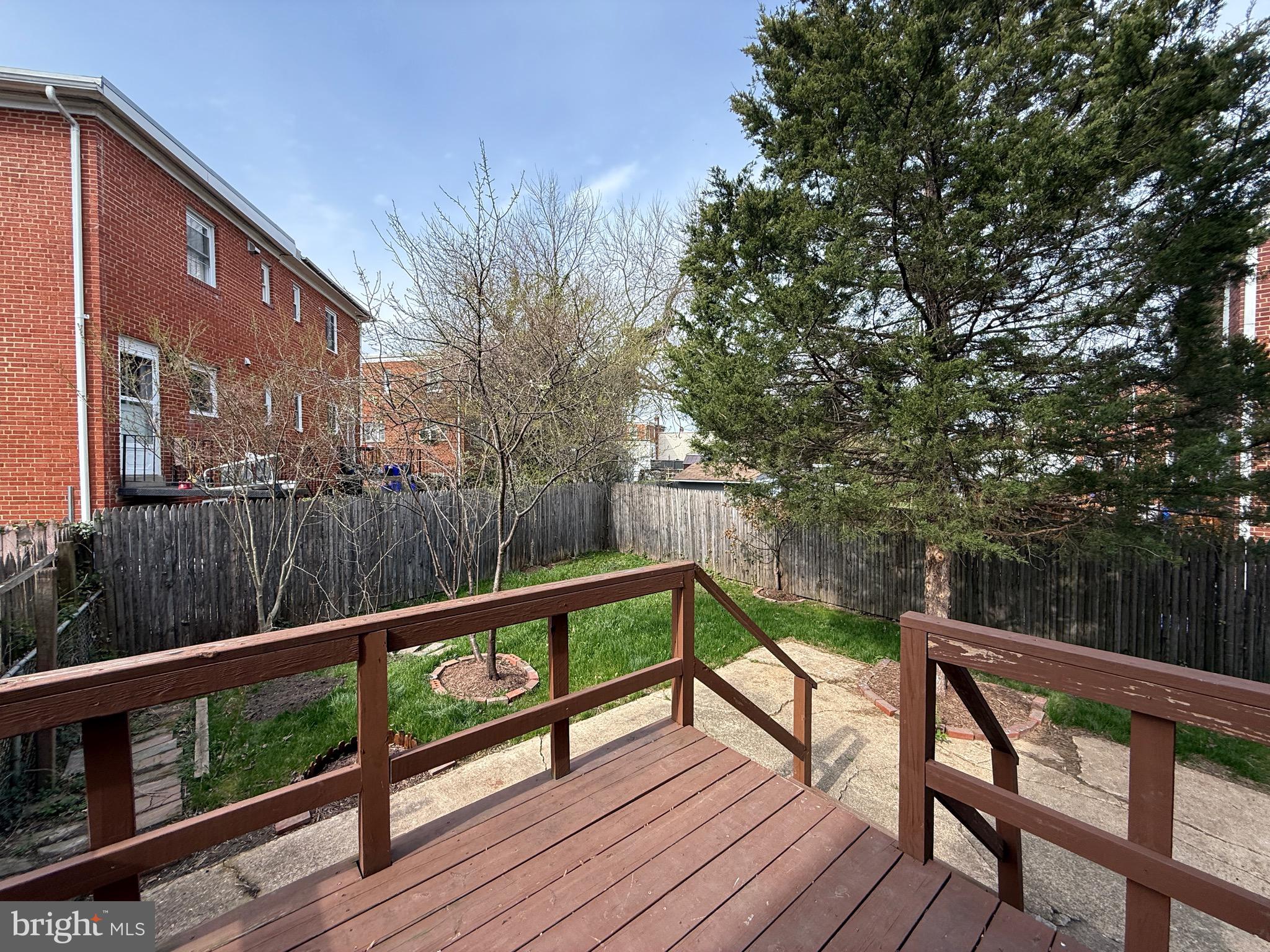 8518 11th Avenue Silver Spring, MD 20903 - Photo 10 of 13 a view of a balcony with wooden floor and bench