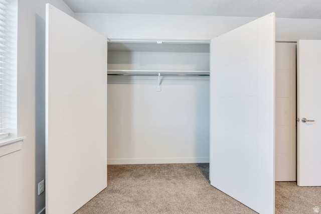 572 South 100 West, Unit E210 Springville, UT 84663 - Photo 25 of 35 Spacious closet with white bifold doors, integrated shelving, and a chrome hanging rod