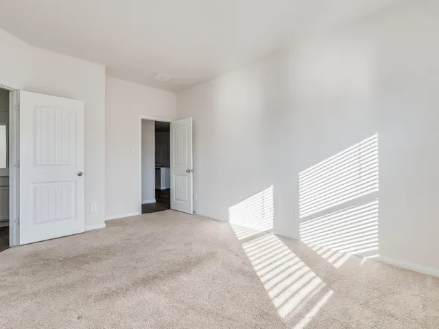 a view of a livingroom with wooden floor and a ceiling fan