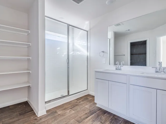 a bathroom with a double vanity sink and mirror
