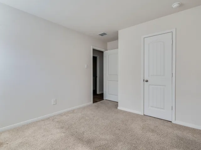 a view of an empty room and closet area