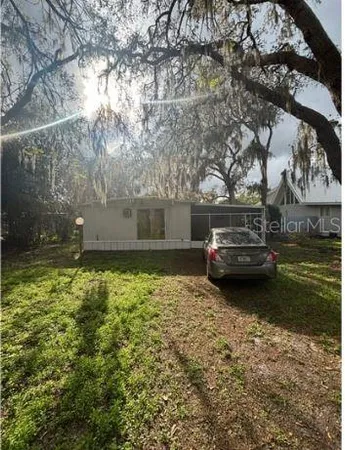 a view of a yard with large trees