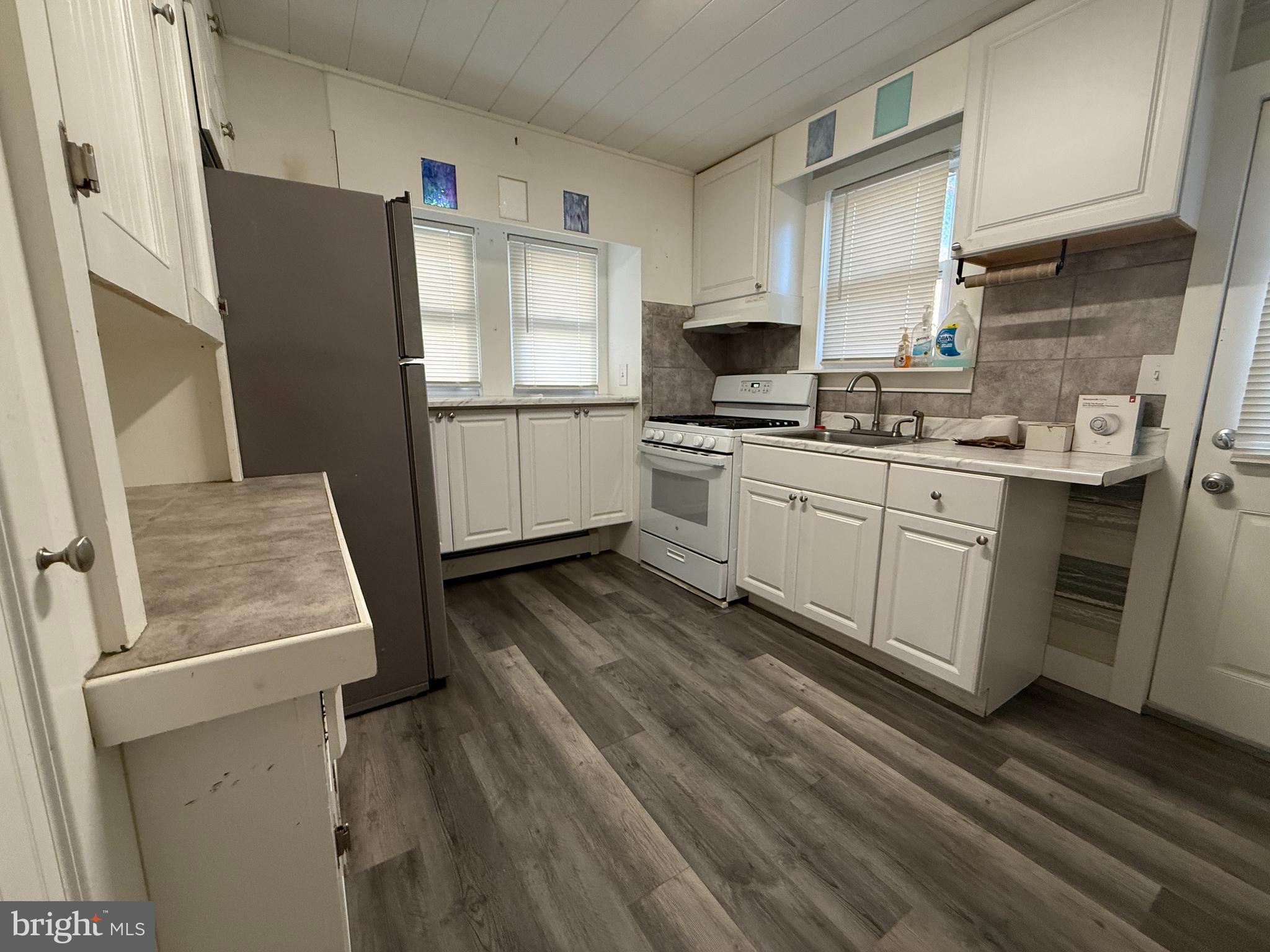930 Tappan Street Forked River, NJ 08731 - Photo 6 of 13 a kitchen with stainless steel appliances a refrigerator sink and microwave