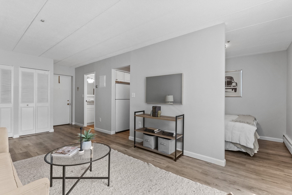157 Franklin Street, Unit A10 Stoneham, MA 02180 - Photo 3 of 10 a living room with furniture and a wooden floor