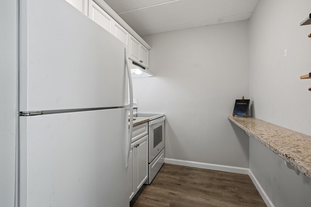 157 Franklin Street, Unit A10 Stoneham, MA 02180 - Photo 5 of 10 a kitchen with a sink and a refrigerator