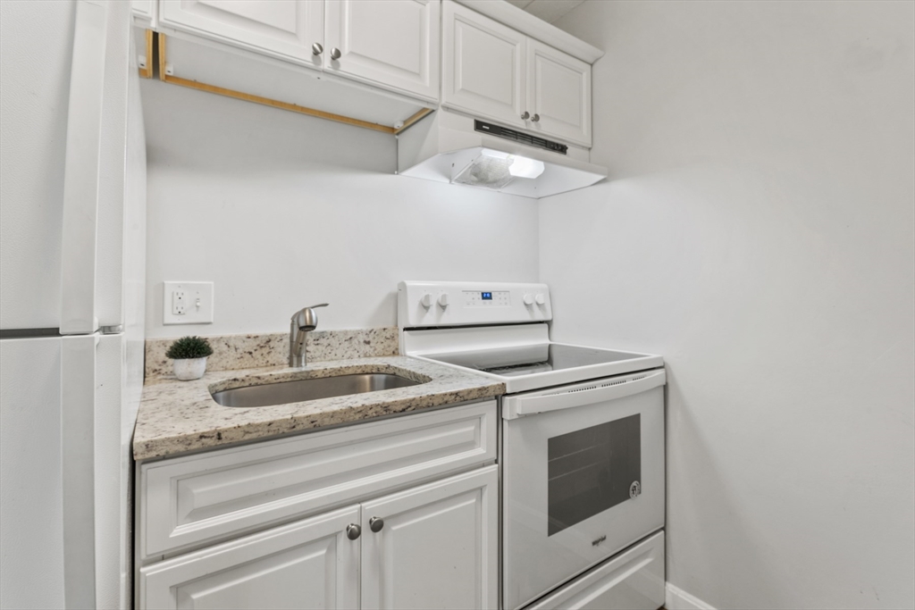 157 Franklin Street, Unit A10 Stoneham, MA 02180 - Photo 7 of 10 a utility room with dryer and washer