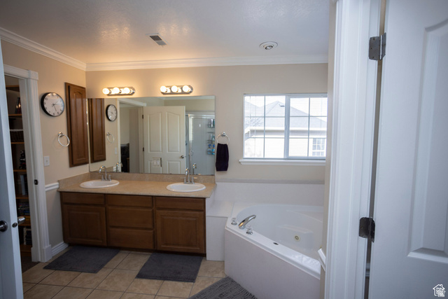 7532 North Castle Rock Road Eagle Mountain, UT 84005 - Photo 21 of 40 Primary Bedroom Full bath featuring double vanity, light tile patterned flooring, a garden tub, crown molding, and a stall shower