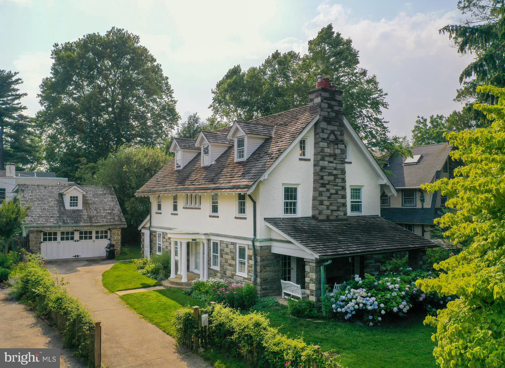 a view of a house with garden and trees