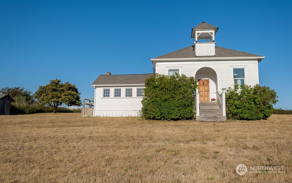 650 Zylstra Road Coupeville, WA 98239 - Photo 2 of 26 a front view of a house with a yard and garage