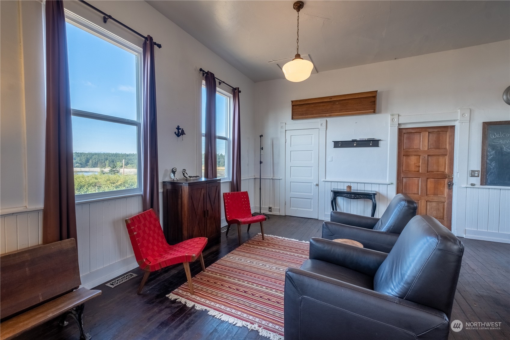 650 Zylstra Road Coupeville, WA 98239 - Photo 4 of 26 a living room with furniture red walls and a chandelier
