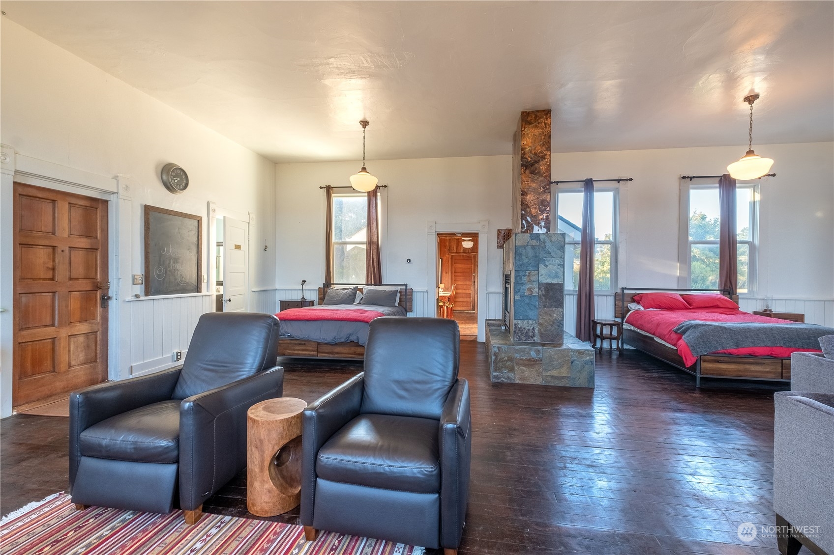 650 Zylstra Road Coupeville, WA 98239 - Photo 8 of 26 a living room with couches and kitchen view with wooden floor