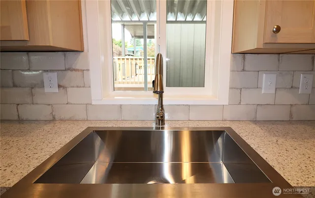a kitchen with granite countertop a sink and a window