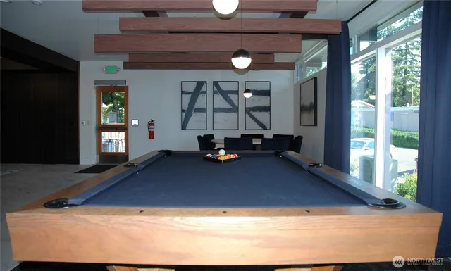 a room with pool table and glass door