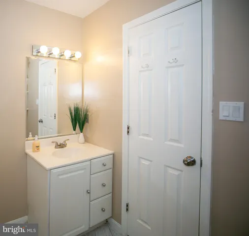 a bathroom with a sink vanity and mirror