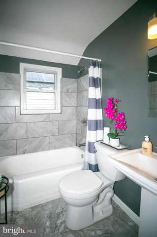 a white bath tub sitting next to a white toilet