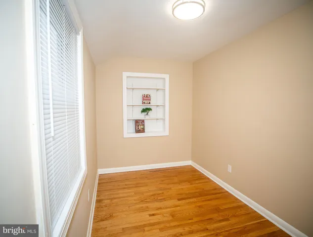 a view of a room with wooden floor and windows