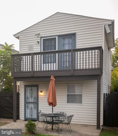 a view of a house with a wooden deck