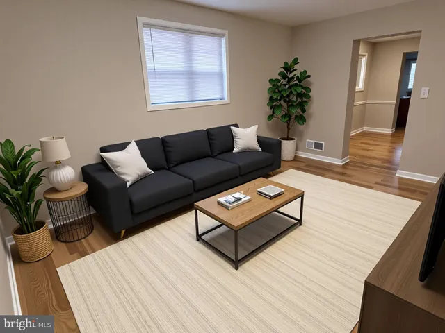 a living room with furniture and a potted plant