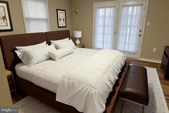 a large bed sitting in a bedroom next to a window