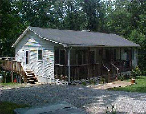 1005 Chandler Road Goodview, VA 24095 - Photo 1 of 3 a house with trees in the background